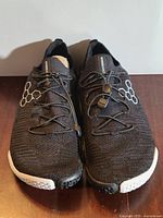 Top view of both shoes showing knit upper, toggle laces, hexagon logo