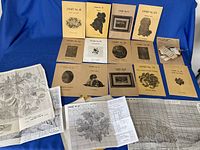 Overview of all Babs Fuhrmann booklets and fold-out charts laid out on blue backdrop