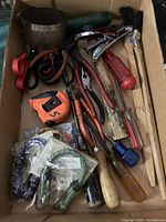 Full view of box showing mixed hand tools and accessories