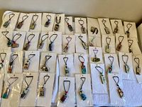 Overview of 40 individually bagged domino pendant necklaces