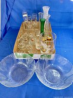 Group shot showing salad bowls, vases, mugs, stemware in tray