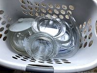 Basket showing stack of glass lids