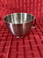 Side view of stainless steel bowl showing handle and brushed finish