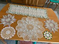 All six crochet doilies displayed on table