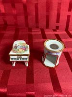 Piano trinket box and candle holder side by side