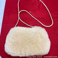 Front view of cream sheepskin handbag with cord strap