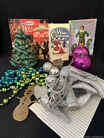 Group view of all Christmas items including tree, media, ornaments, garlands, candle