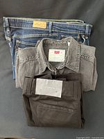 All three garments folded: jeans, sleeveless shirt, shorts with tag