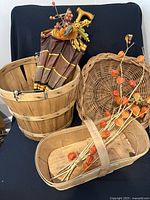 Four items grouped: three baskets and closed umbrella with fall stems