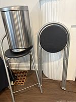 Garbage can and both folding stools; shows overall appearance and materials