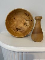 Front view of willow bowl and oak vase showing overall shape and grain