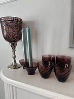 Group shot showing mosaic hurricane, six tumblers, two votive holders, two taper candles