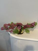 Full view of glass floral arrangement on shelf