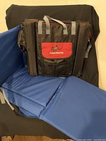 Blue pocket seat unfolded to display seat cushions and backrest