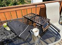 Grate folded flat beside black vinyl storage bag on glass table