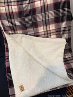 Overall view of blanket showing plaid pattern and fleece reverse