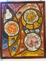 Front view of hand-hooked floral textile art in teak frame