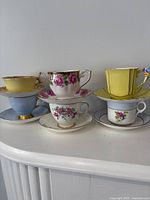 Front view of all six teacup and saucer sets