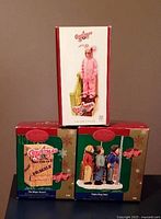 Three boxed Carlton Cards A Christmas Story ornaments displayed