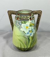 Front view showing floral painting and both geometric handles