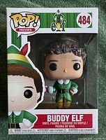 Front of Funko Pop Buddy Elf #484 box showing figure inside