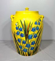 Front view showing floral design, lid, handles