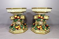 Pair of Fitz and Floyd Christmas pillar candle holders front view