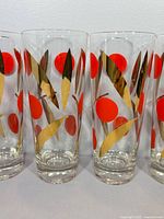 Four highball glasses showing full height and decoration