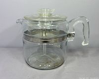 Full view of assembled glass percolator, lid on, side handle visible