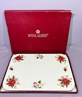 Closed red Royal Albert box with placemats inside