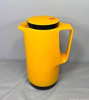 Front view of orange Dr. Zimmerman thermos showing lid, spout, handle, and base