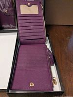 Wallet open showing card slots, ID window, zipper edge