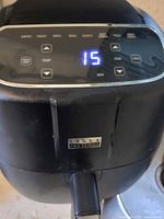 Front control panel displaying 15 minutes with function buttons visible