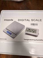 Front of retail box showing esppds digital scale and mini thermometer-hygrometer