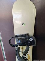 Full view of nose section of snowboard with binding attached
