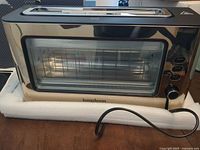 Front view of Longdeem stainless steel vision toaster on foam base, power cord visible