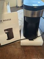 Coffee maker with manual on foam pad