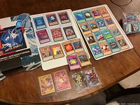 Overview of trading cards displayed in trays and Yu-Gi-Oh! blanket package