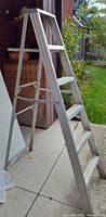 Side view of aluminum A-frame step ladder opened