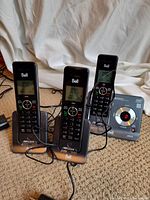 Three Bell handsets on individual cradles with separate answering base unit