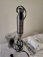 Immersion blender, hand mixer, cord and attachments visible