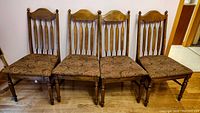 Front view of four matching wood dining chairs