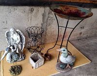 Overall lot showing bird bath, statues, plant stand, planters