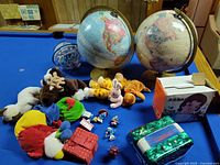 Overview showing globes, Perplexus sphere, plush toys, Smurf figurines, toy accordion, tissue pack