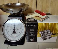 Overall view of Typhoon kitchen scale, Marcato Atlas 150 pasta maker box and ravioli roller
