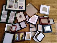 All 23 assorted picture frames laid out on floor