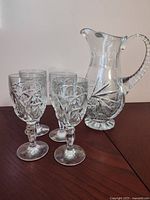 Pitcher and four goblets grouped on table