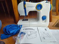 Full view of sewing machine with accessories and manuals