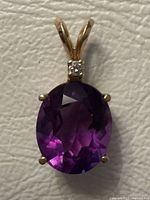 Front view showing amethyst, diamond accent and gold setting