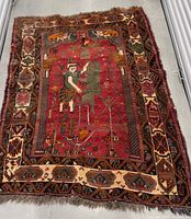 Full view of entire Shiraz rug showing overall design, fringe and irregular shape